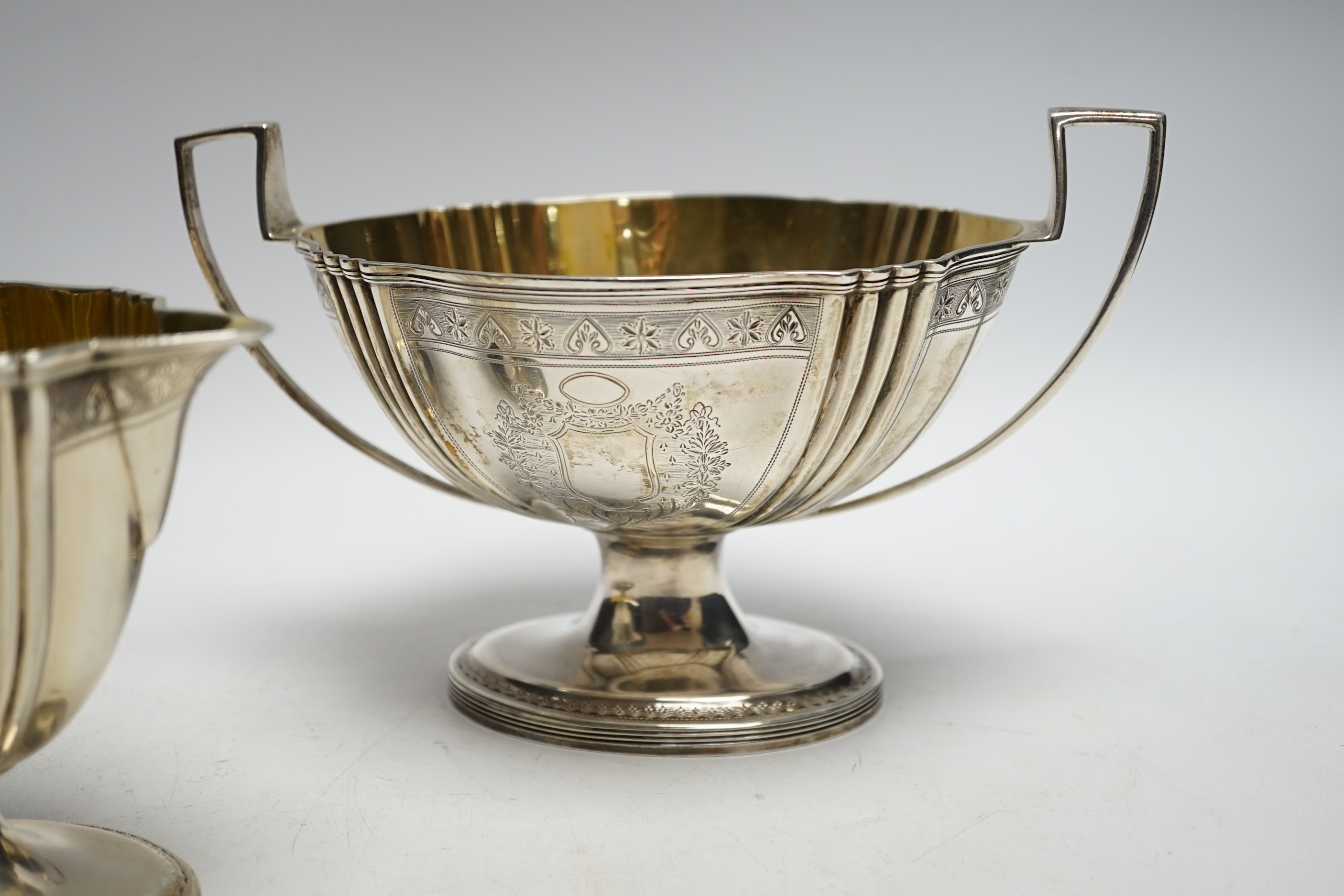 A George III engraved silver two handled oval pedestal sugar bowl and matching cream jug, Henry Chawner, London, 1792, bowl 21.2cm over handles, 20.1oz.